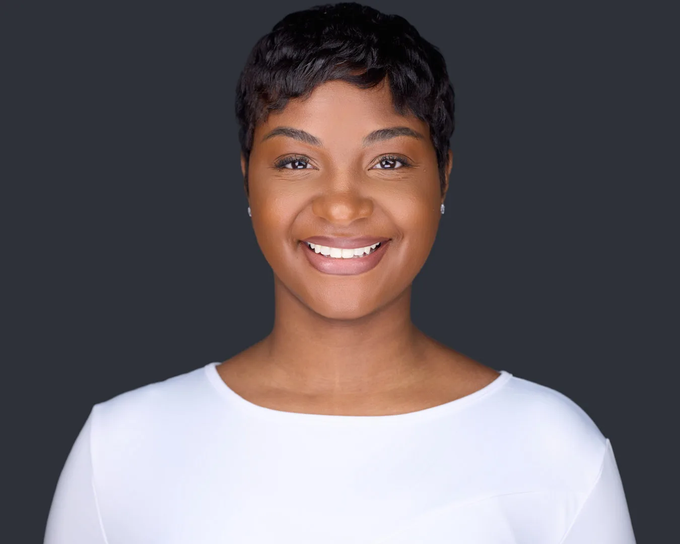 Victoria Thompson professional headshot in white top with short pixie cut